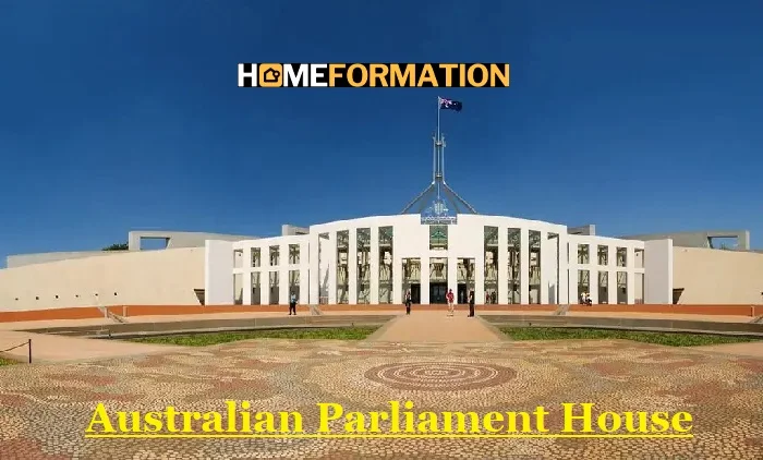 Aerial view of Australian Parliament House in Canberra, showcasing its iconic flag mast and distinctive architectural design against Capital Hill's landscape