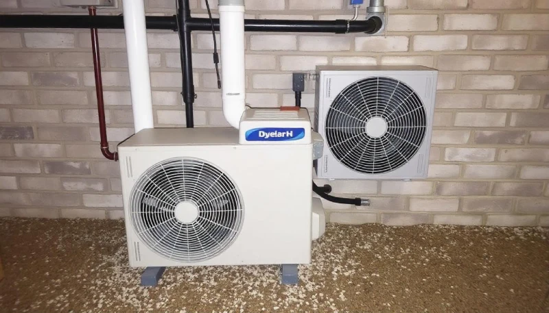 Modern basement AC unit installation showing professional HVAC setup with proper ventilation and drainage systems.